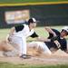 A Pioneer player attempts to tag out a Saline player during a double header on Monday, May 20. Daniel Brenner I AnnArbor.com